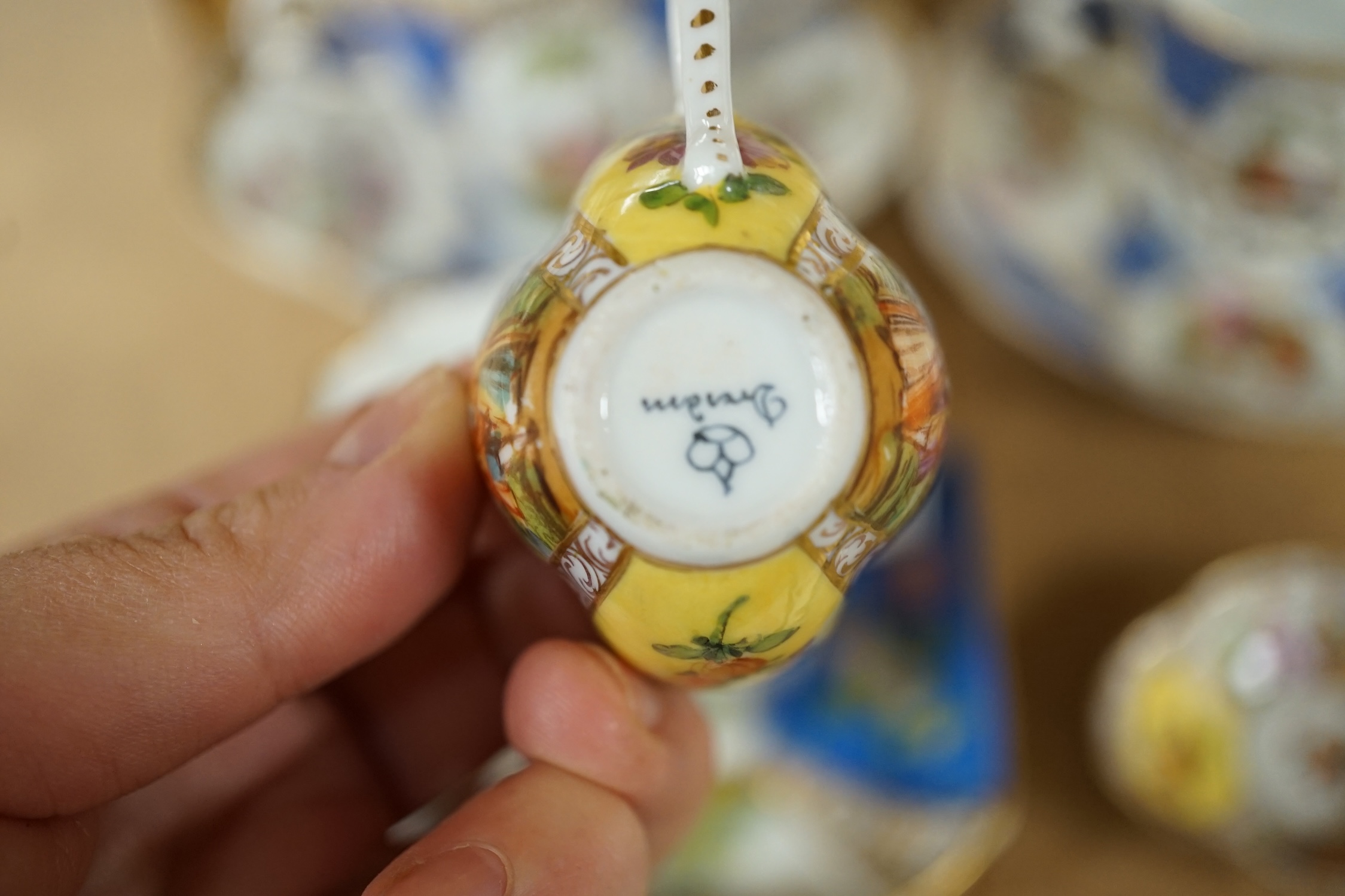 A Crown Dresden porcelain cup and trembleuse saucer, and three other Crown Dresden cups and saucers, largest 14.5cm wide. Condition - good